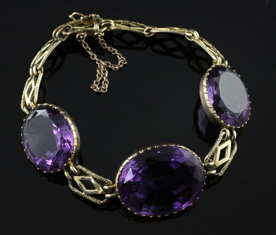 A gold and amethyst bracelet, approx. 6.25in.